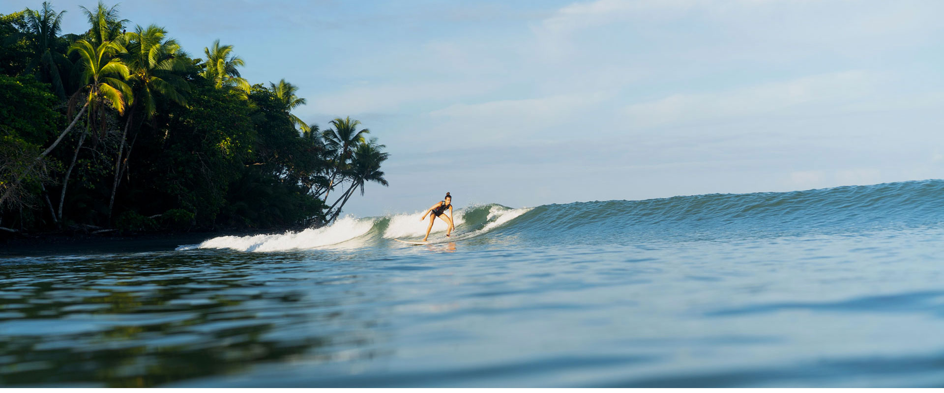 Surfer riding a wave at Playa Venao, Panama